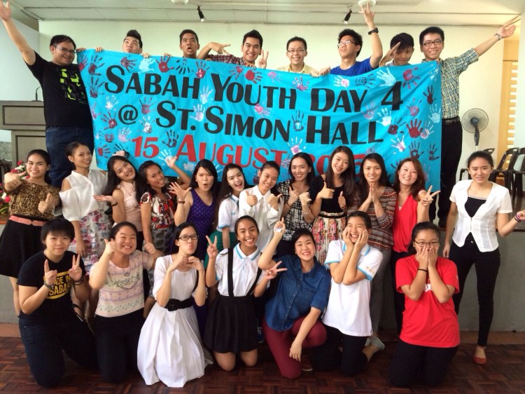 The St Simon Parish youths posing with the banner on the event of welcoming the Sabah Youth Day 4 cross to the parish. Also seen in pic is the Youth Ministry leader Mirina Lim (middle row, second right). 