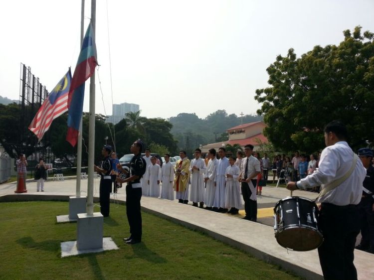 Boy scouts seen during the flag-raising ceremony while Fr Mathius and the altar servers look on.